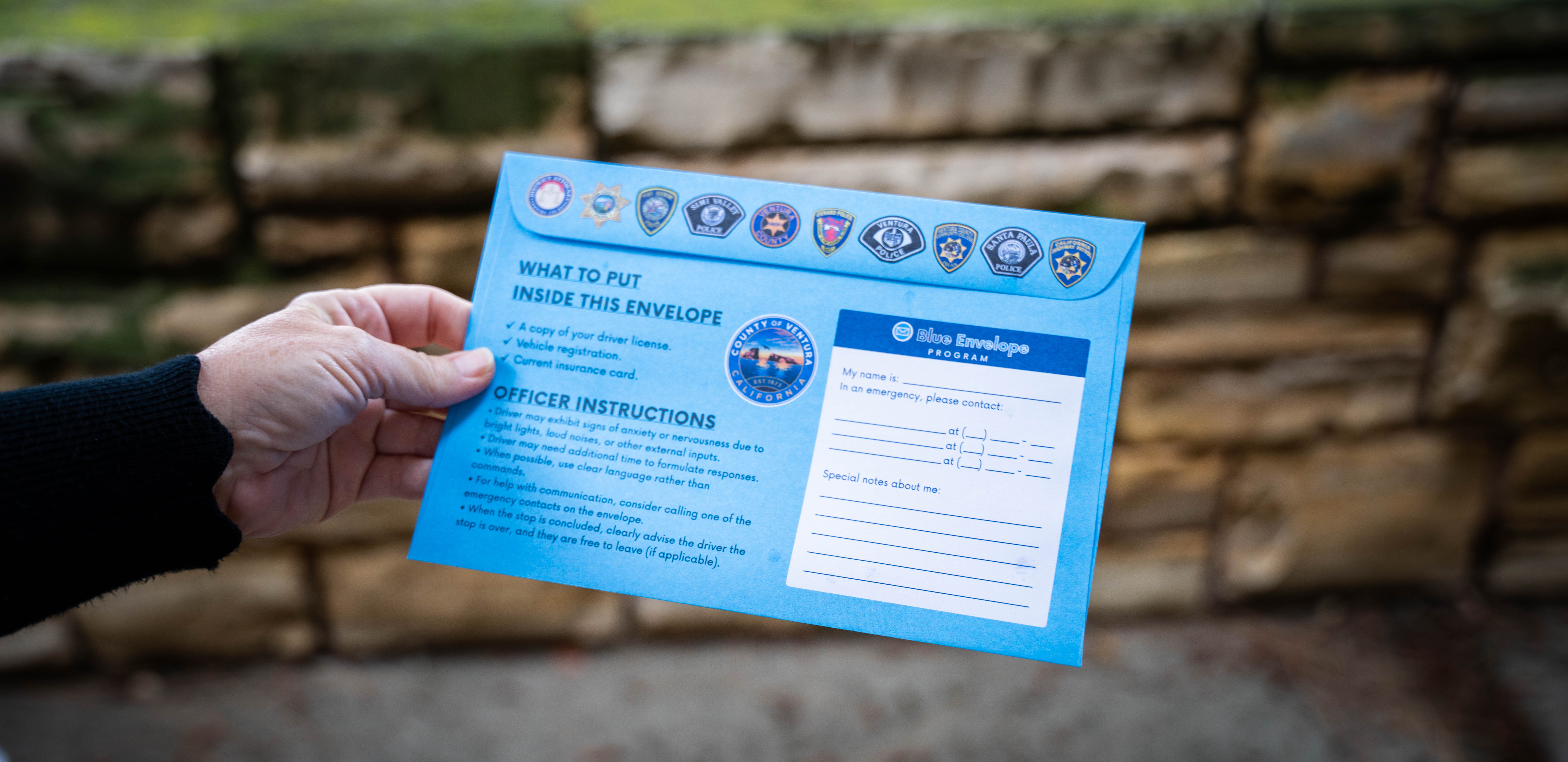 Photo of a person holding a Ventura County Blue Envelope