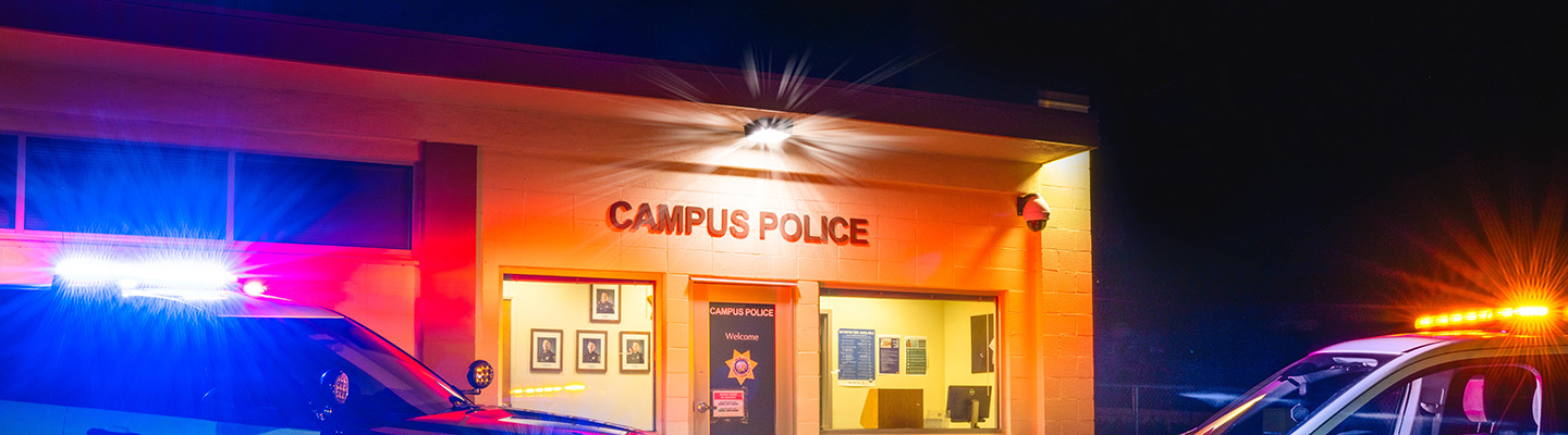 Photo of the VC Station taken at night with the top of a patrol car and a support services truck.