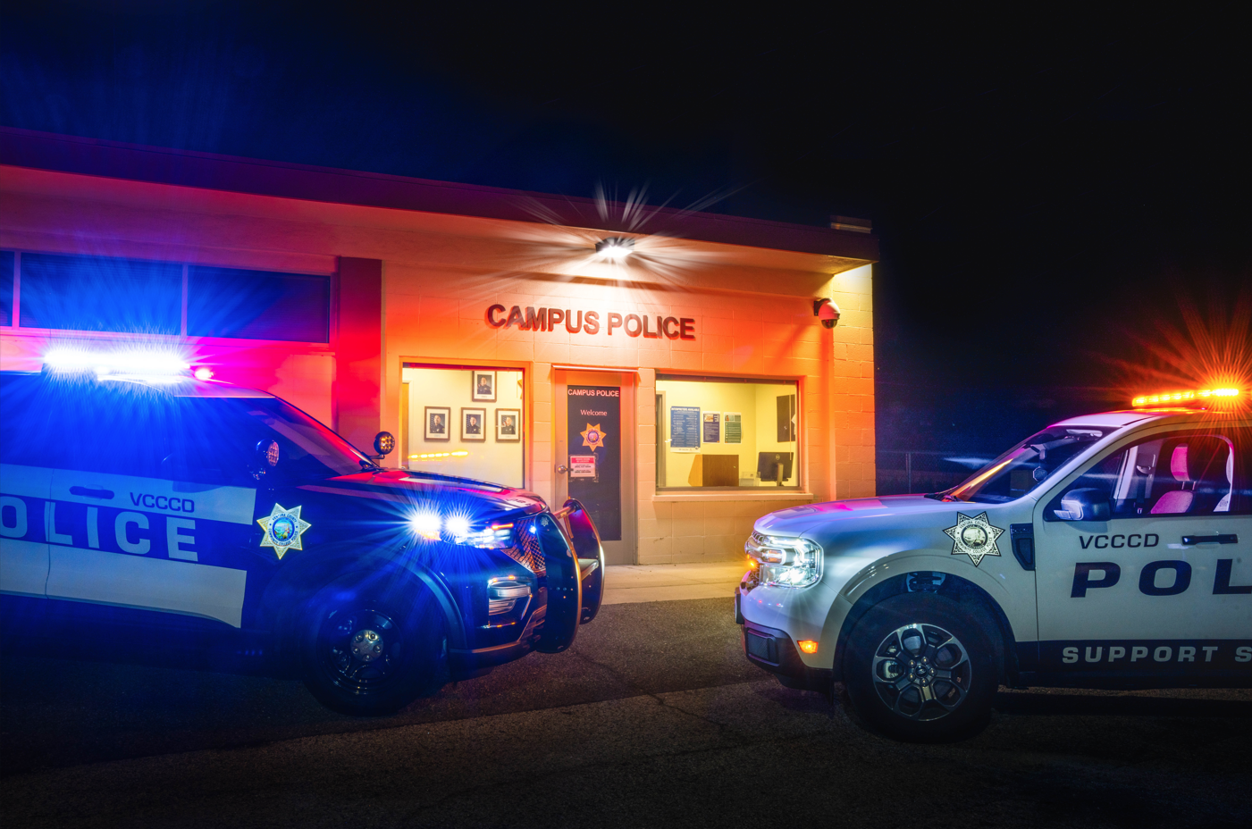 Photo of the VC Station taken at night with the top of a patrol car and a support services truck.
