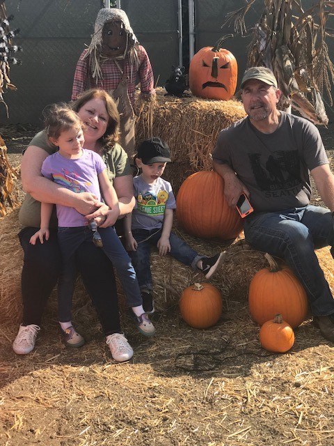 Beth Thompson with grandchildren at the pumpkin patch.