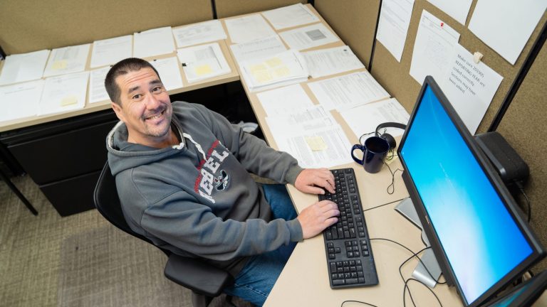 John Cooney at his desk.