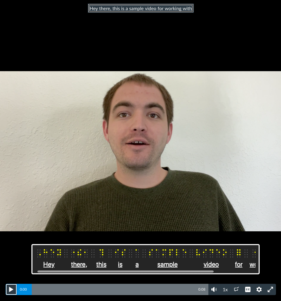 Webpage screenshot, captions are displayed within a studio video, the VoiceOver screen reader shows the braille panel with the captions displayed in braille code