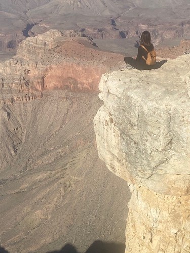 Holly Corea sitting on a rock