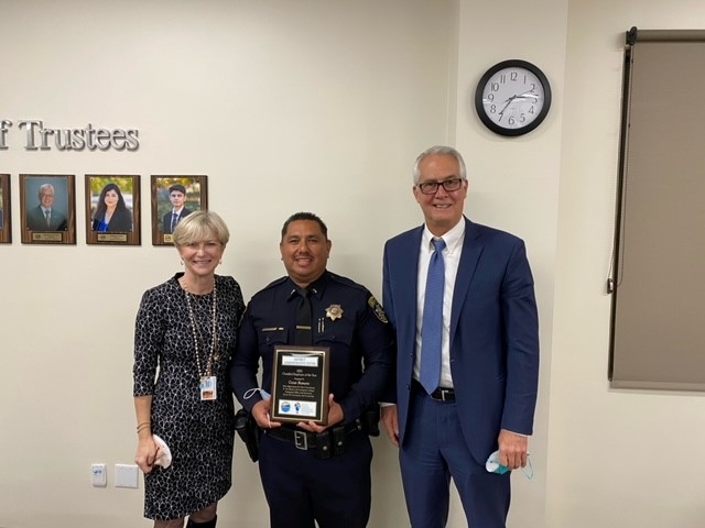 Board Chair McKay and Chancellor Gillespie present Lt Cesar Romero with the Classified Employee of the Year for Districtwide Services / District Administrative Center