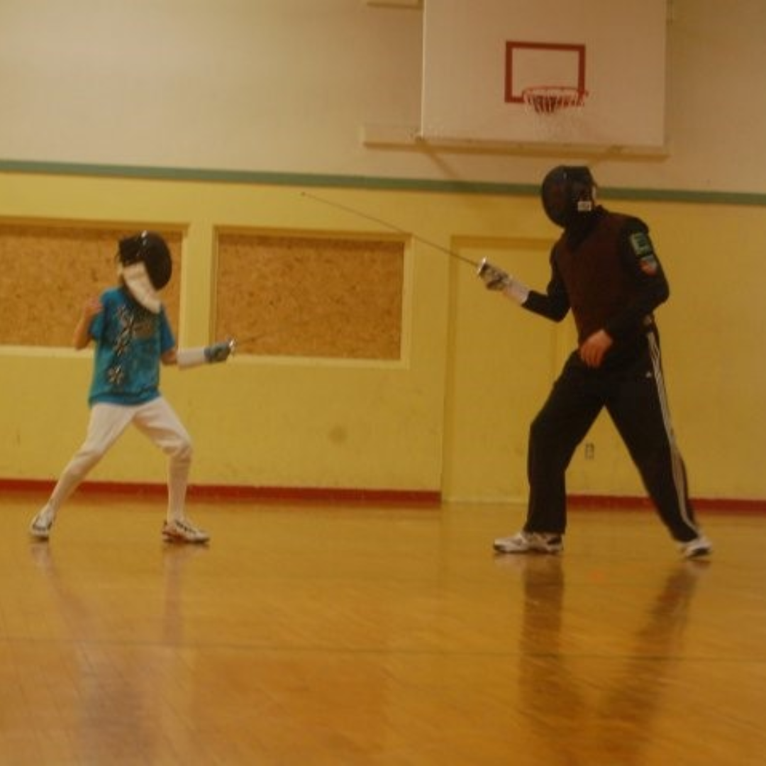 Image of Eric McDonald fencing with a student