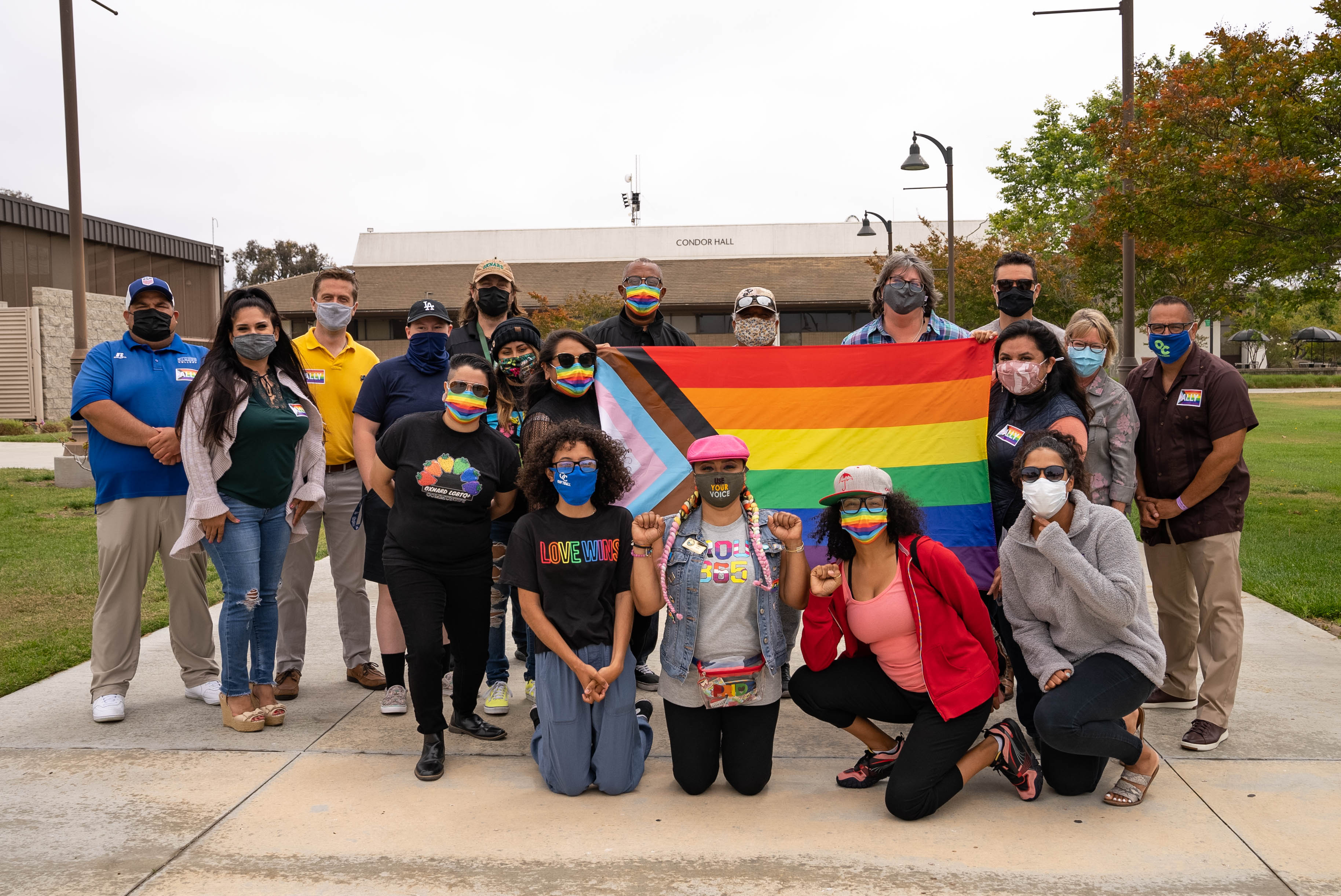 Oxnard College students and employees holding the LGBTQ+ Pride Flag