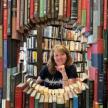 Beth in a frame of books