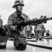 Fire Captain holding a fire hose.