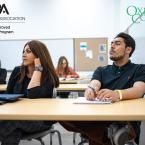 Photo of students sitting in class listening to a lecture an