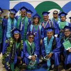 A group of Oxnard College students in graduation gowns