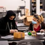 Two Oxnard College students in a classroom wearing masks.