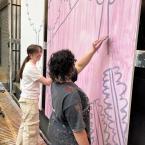 students painting a backdrop for the tempest