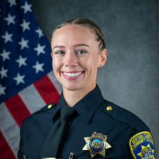 Official department photo of Officer Caitlyn Hughes in her Class A uniform.