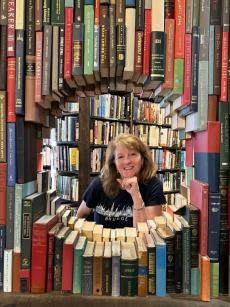 Beth in a frame of books
