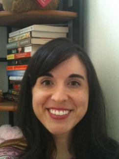 Picture of Prof. Scrofano standing in front of a bookshelf