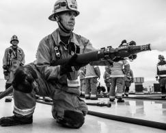 Fire Captain holding a fire hose.