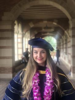 Dr. Schmidt standing in regalia at UCLA