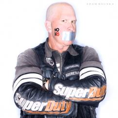 Mr. P in his riding leather with NOH8 stenciled on his cheek and duct tape over his mouth