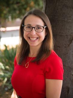 Woman in red top with glasses