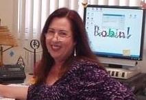 Portrait of Robin Douglas sitting at her desk