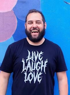 Nick Norton wearing a black Live Laugh Love T shirt in death metal font