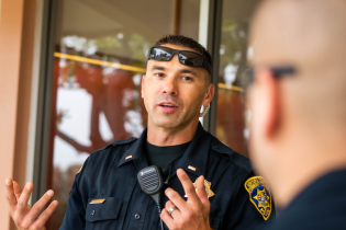 Photo of Lt. Pallotto speaking with another officer.