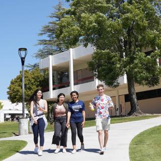 Four Moorpark College students walking around campus.