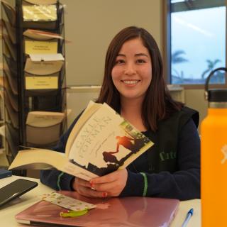 Student reading a book at the OC Library