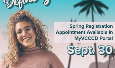 Woman with curly hair and glasses holding a book standing in front of palm trees. Define your future; Spring Registration Appointment available in MyVCCCD portal Sept. 30