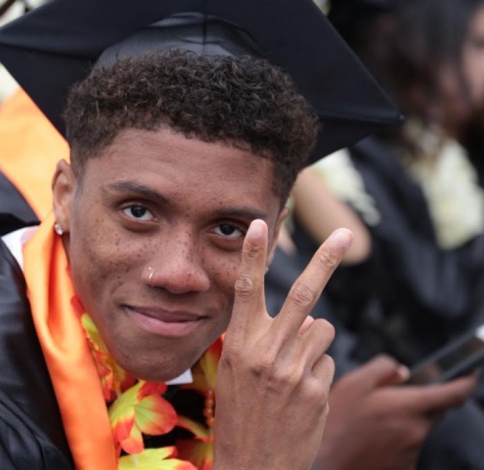 ventura college graduate giving peace sign