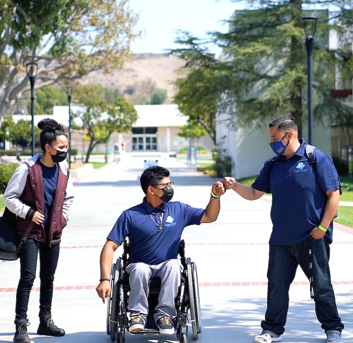 Three students heading down Raider Walk