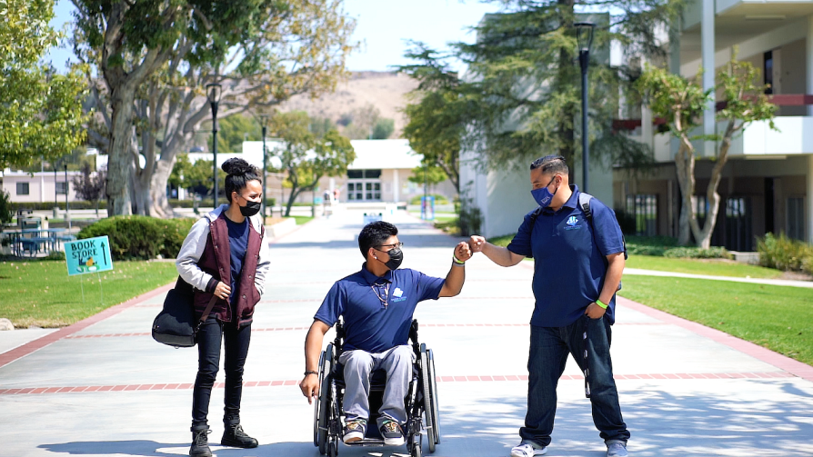 Three students heading down Raider Walk