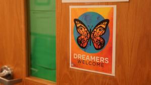 Sign on a door with a butterfly and the text "Dreamers Sign on a door with a butterfly and the text "Dreamers