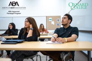 Photo of students sitting in class listening to a lecture an Photo of students sitting in class listening to a lecture an