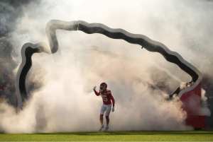 Kansas City Chiefs player wearing number 35 runs onto the fi