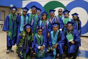 A group of Oxnard College students in graduation gowns