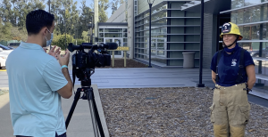 Person filming a fire cadet at the Oxnard College Fire Academy.