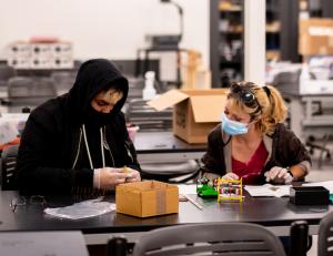 Two Oxnard College students in a classroom wearing masks.