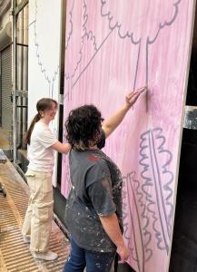 students painting a backdrop for the tempest