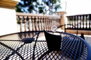 Photograph of a trophy on a black table. Trophy includes text "2023 Pro Awards Folder Ventura County CCD Ccpro"